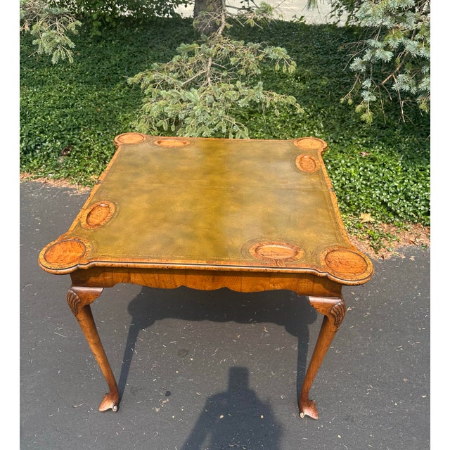 Stunning 18th Century Burl wood leather flip top table measuring 32 1/4” x 33 1/4” x 28 1/4” h. Shell carved cabriole legs...