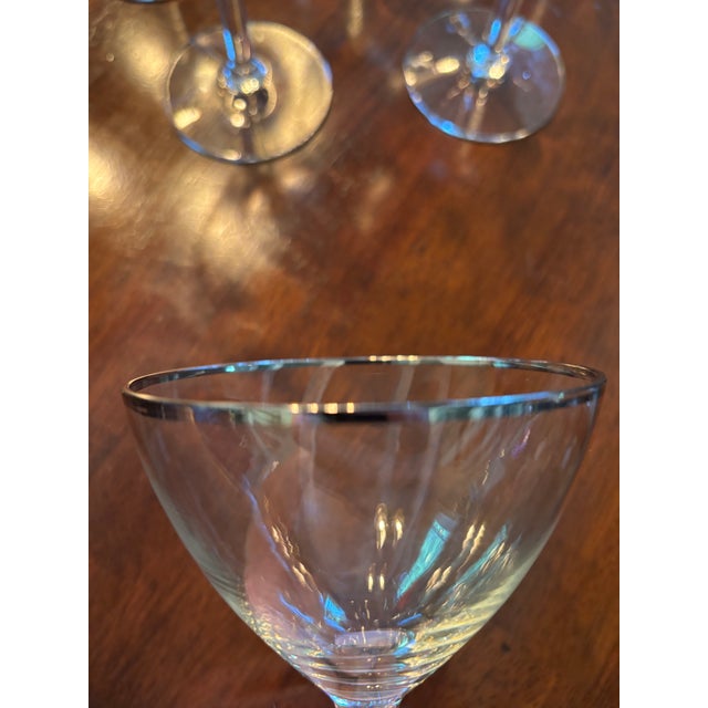 Cocktail Coupe Glasses with a Silver Rim around the Top. Hand wash recommended.