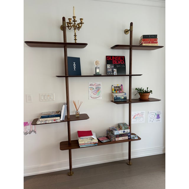 The Ketch bookcase features a sleek steel frame with brass lacquered finish, offering a modern, architectural look. Its...
