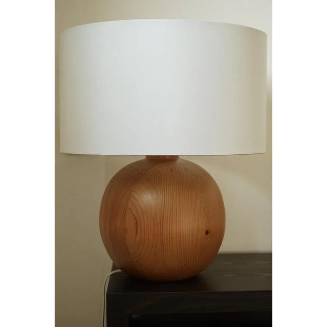 Solid pine lamp constructed from sections of solid pine wood. Without the shade it measures 27cm high and 25cm diameter. I...