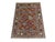 This Philpa Bokhara design wool rug features twelve repeating elephant foot motifs across a slate blue-gray field. Rich...