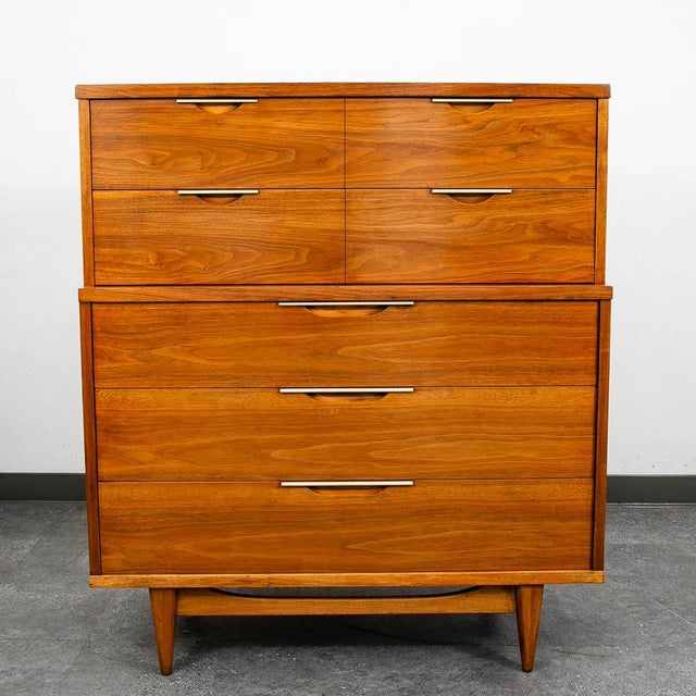 Handsome sculptural mid century modern Highboy in walnut by Kent Coffey for the Tableau collection. Comes with 5 drawers...