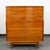 Handsome sculptural mid century modern Highboy in walnut by Kent Coffey for the Tableau collection. Comes with 5 drawers...