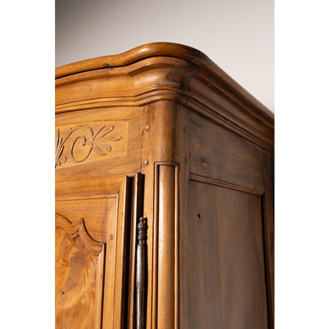A monumental French provincial walnut marriage armoire dating to the late 18th or early 19th century. Traditionally...