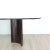 A modern glass top dining table on metallic finished wood pedestals, U.S.A. circa 1970.