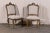 A pair of richly carved Italian, 18th century Venetian style upholstered chairs with slanted backs. The chairs Stand on...