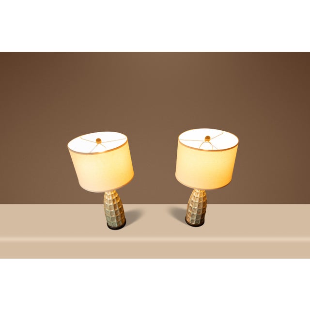 Introducing a pair of vintage, 70's era textured rough glazed ceramic table lamps. Ideal for designers searching for the...