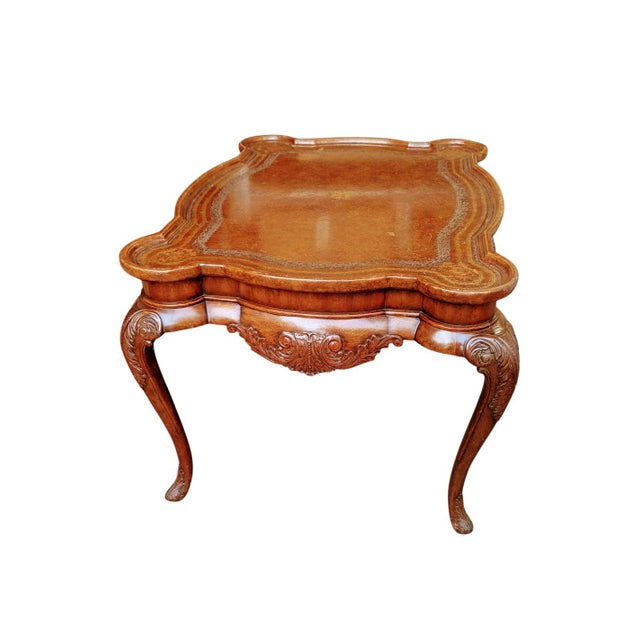 This elegant piece is a Louis XV-style coffee table, crafted from carved mahogany. This table features a distinctive...