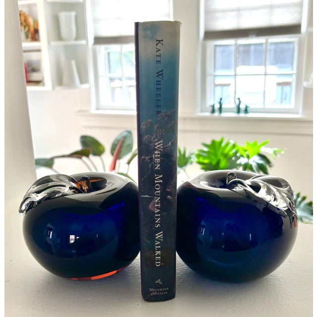 Pair of vintage apple Murano style glass bookends. Unusual coloring which shows blue, black, or even amber, depending on...