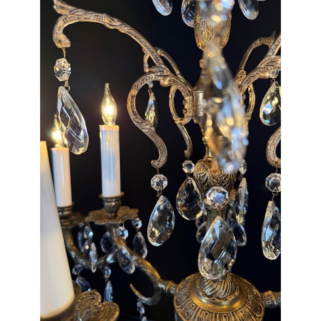 Vintage Spanish Brass Chandelier with Crystals - 10 Lights Gracefully crafted in Spain, this elegant vintage chandelier...