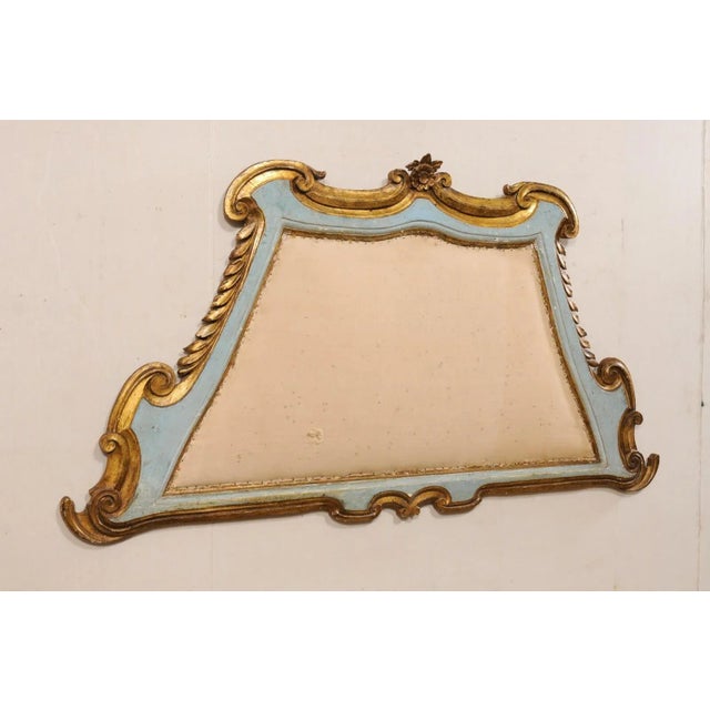 An Italian carved and gilt wall-mounted headboard, with upholstered center, from the early 20th century. This antique...