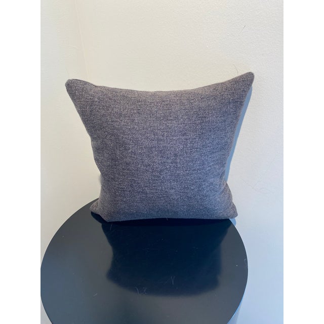 This stylish throw pillow features a versatile dark gray, textured fabric that adds both comfort and modern sophistication...