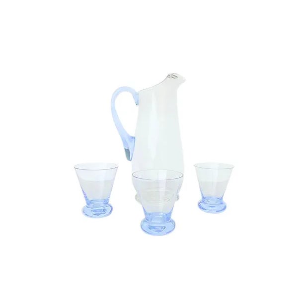 4-Pieces of clear glass juice service with fine translucent blue accent. Dimensions: pitcher, 5.5"Dia x 10"H; three...
