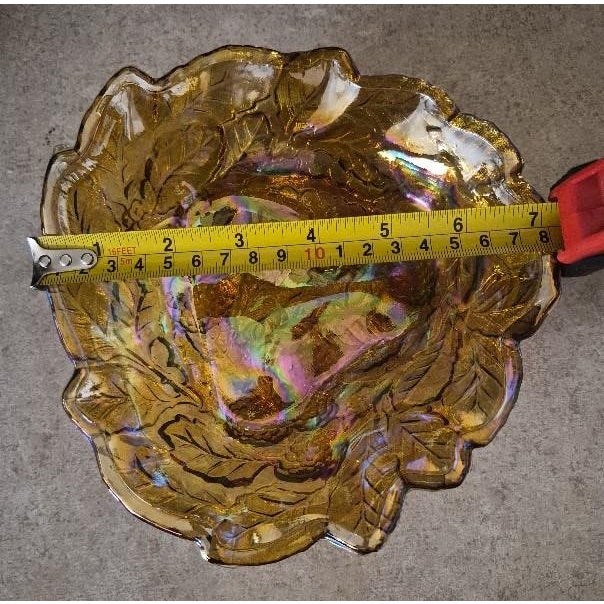 Up for sale is a beautiful vintage iridescent amber carnival glass bowl featuring an ornate grape and leaf pattern with a...