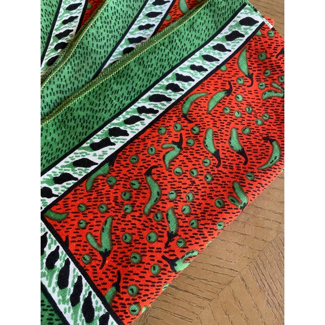 Set of four vibrant and festive red and gree linen dinner napkins with a chili motif. Signed Katya. Unfolded, each is a...