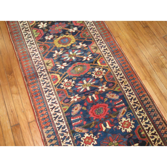 Highly decorative long runner Persian Varamin runner from the early 20th century. Measures: 2'11'' x 17'5'' Varamin...