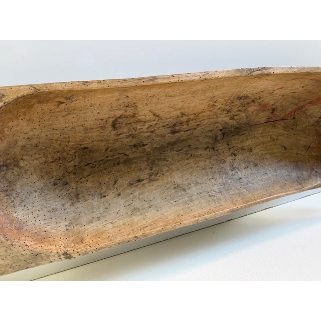 Beautiful antique primitive hand-carved wood dough bowl featuring a long, organic form and rich natural patina developed...