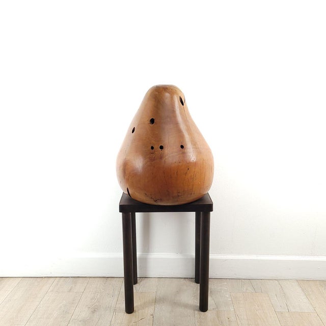A treen carving of a pear in pear wood on a custom stand. The pear measures 20" h x 18" w x 17.25" d, and the stand...