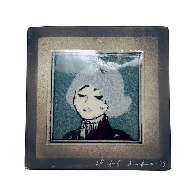 A fine vintage collectible Arabia porcelain wall tile depicting the portrait of a woman, signed by Heljä Liukko-Sundström...