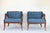 French Louis XVI style lapis blue tub armchairs, circa 1960s. They feature curved wood trimmed low backs, oval cut-out...