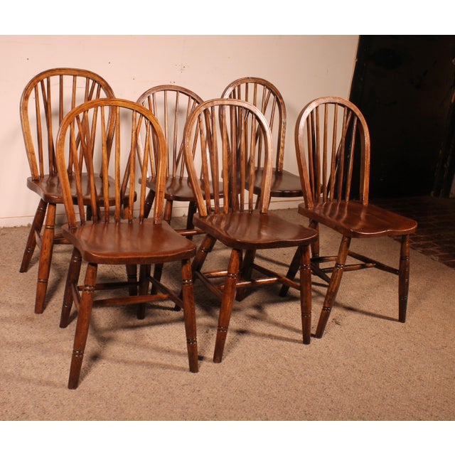 Exquisite set of six 19th-century English Windsor chairs in oak. A beautiful set with a lovely patina. They feature...