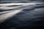 This photographic work captures the ethereal movement of waves, rendered with a soft, flowing quality that emphasizes...
