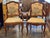 A pair of 19th century French walnut armchairs with shaped upholstered backs, curved open arms, and upholstered seats,...