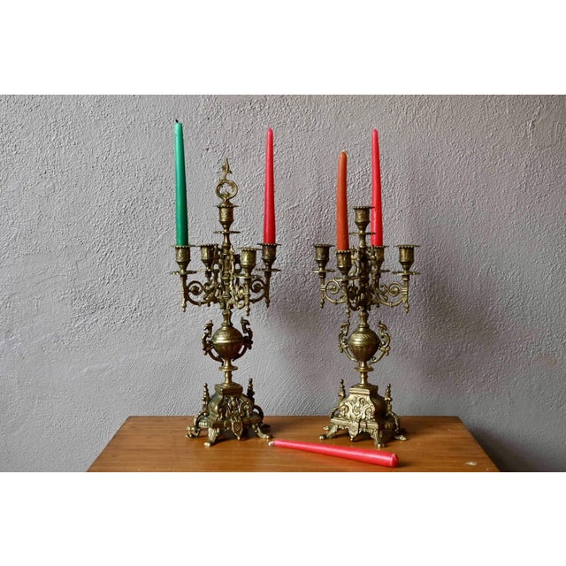 This pair of antique candlesticks is majestic, a style frequently found in cathedrals. In a Baroque style, these five-...