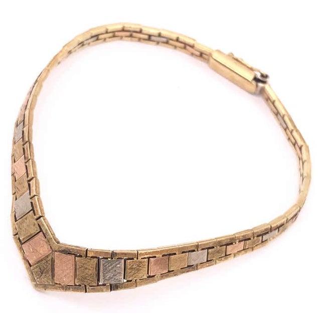 14 Karat Italian Three Tone Gold 7 Inch Fancy Link Bracelet 11 grams total weight. 7mm width