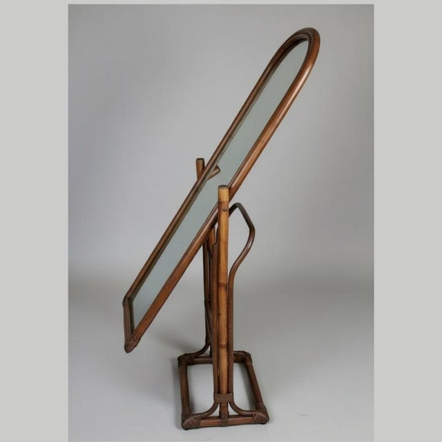 Vintage french cheval mirror in rattan from the 1960s-70s, with a hot-bent rattan frame and joints made with split rattan...