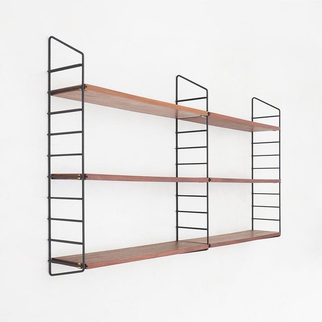 Wall-mounted bookcase, 1960s, characterized by a clean and rigorous design, representative of Italian functionalism of the...