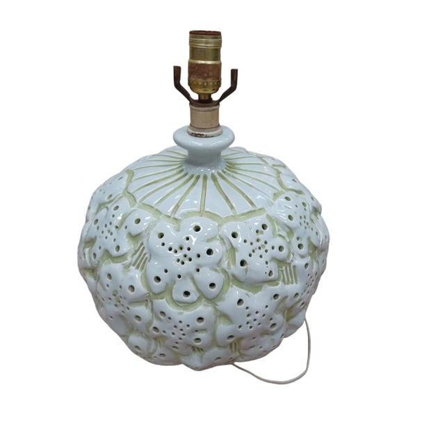 Vintage ceramic pottery lamp with green and white color. Interior of daisies are pierced.