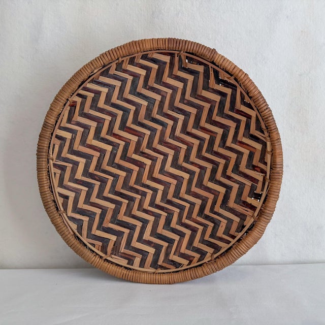 Beautiful vintage winnowing basket from Kenya, dating to the late 20th century. The basket is hand woven in a chevron...