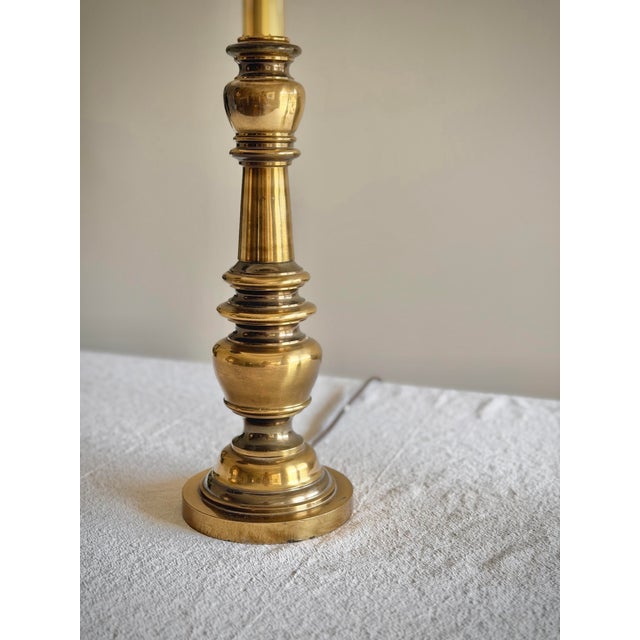 A handsome matched pair of vintage brass table lamps, dating approximately to the 1960s–1970s, with sculptural baluster-...