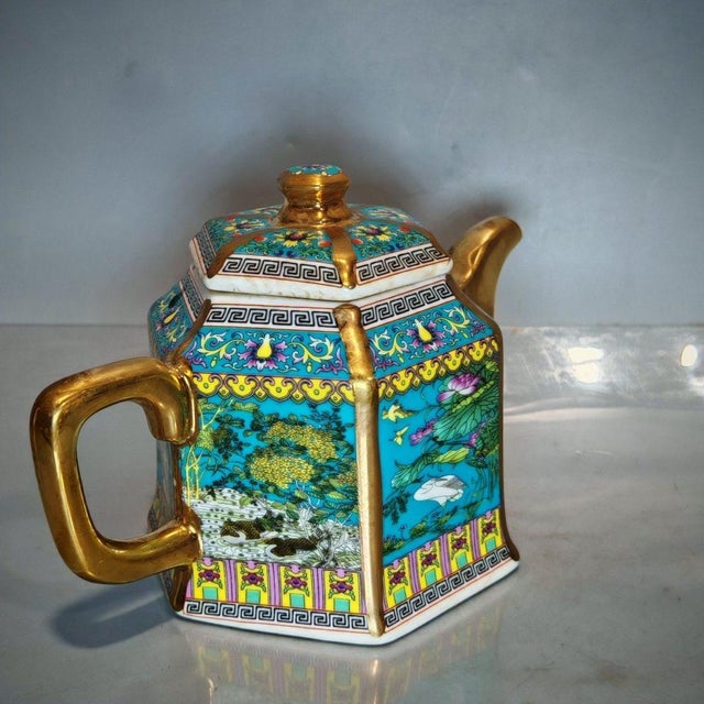 Luxurious hexagonal Chinese famille rose porcelain teapot with lavish gilded handle, spout, lid finial and raised trim....