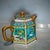 Luxurious hexagonal Chinese famille rose porcelain teapot with lavish gilded handle, spout, lid finial and raised trim....