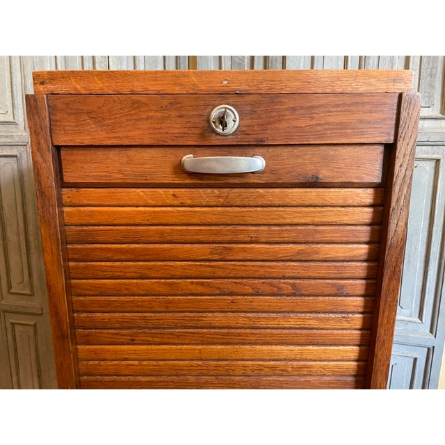 Beautiful roll-up cabinet from the Art Deco period of the 1930s in France. The cabinet features a smoothly operating roll-...