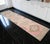 Woven in the celebrated workshops of Oushak during the 1970s, this authentic Turkish runner rug showcases a refined...
