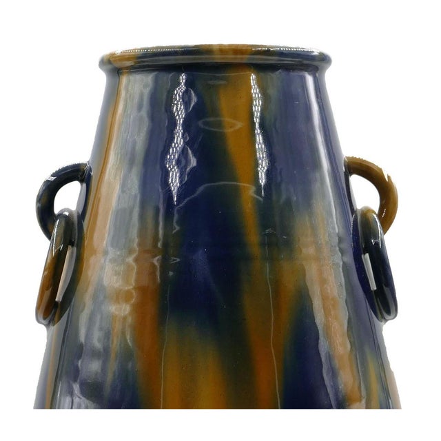 Vase with rings is an original decorative object realized in the first half of the 20th century. Original colored glazed...