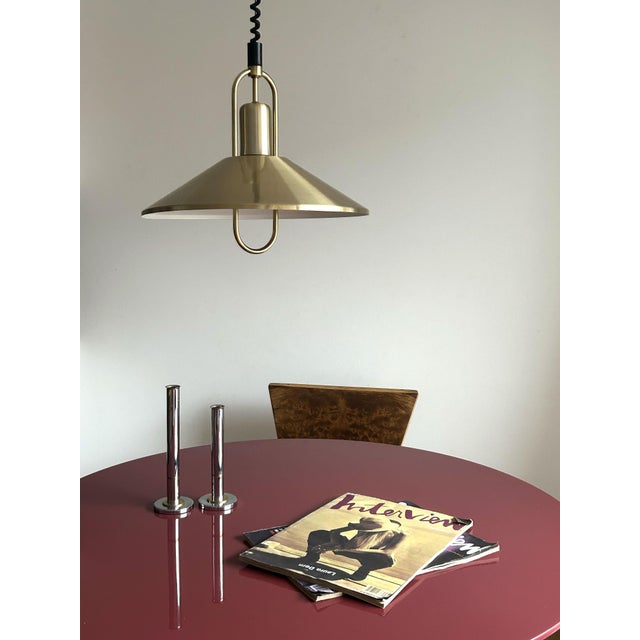 A classic Danish pendant lamp from the 1970s, in brushed brass-toned aluminum. It has a warm, soft golden finish with some...
