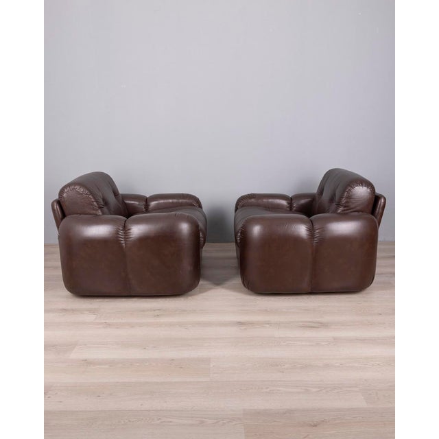 Pair of large armchairs with brown leather upholstery, designed by Ceriotti, 1970s. This piece has an attribution mark, I...