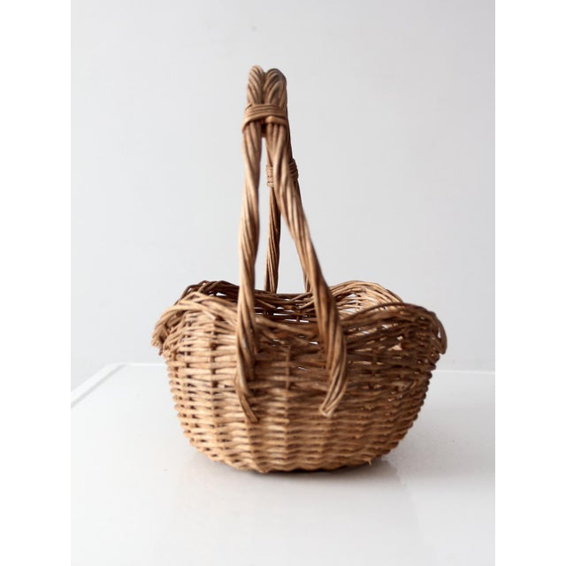 This vintage willow gathering basket features a tall arched handle, open weave, and beautifully organic shape. Filled with...