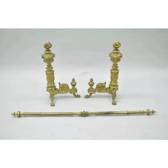 Pair of 19th C. French Empire Neoclassical Flame & Lion Brass Paw Andirons & Bar. Item features an ornate pair of cast...