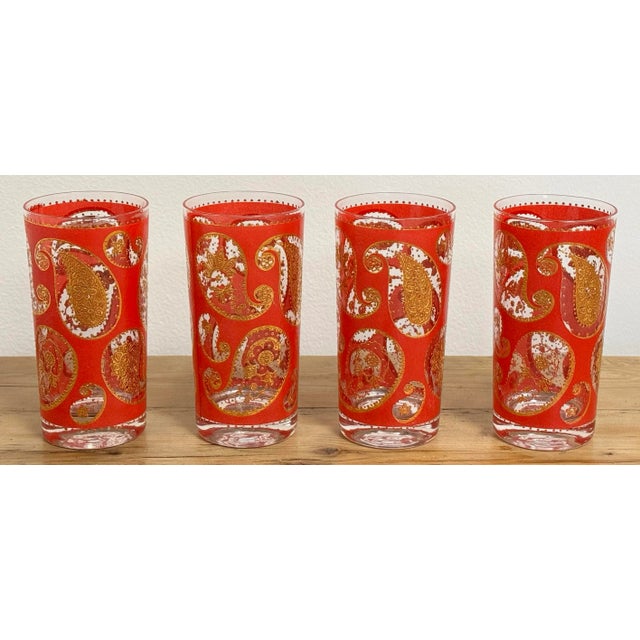 Set of four vintage highball glasses featuring red background with gold gilt paisley pattern throughout. This set of four...