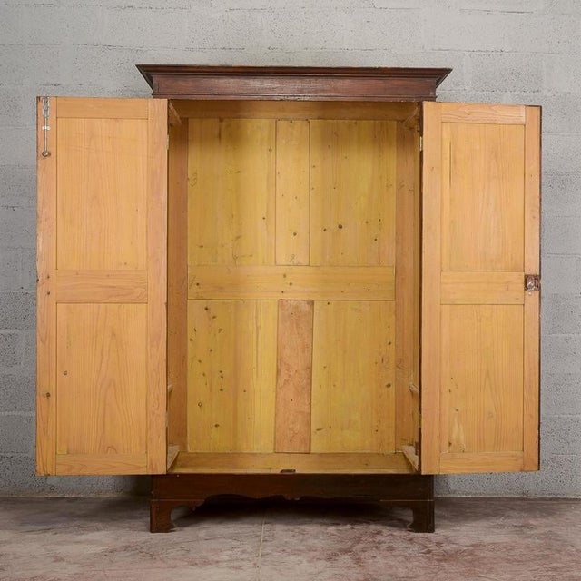 This antique two-door cabinet embodies the authentic charm of vintage furniture, perfect for lovers of historic design and...