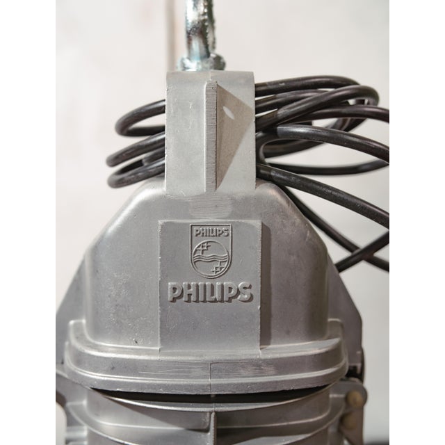 A 1950s philips hdk series factory pendant light in black enamel with a cast aluminum top, made in the netherlands. This...