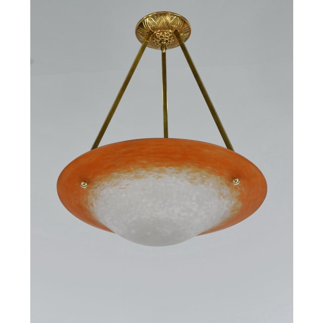 Charles Schneider A beautiful small 1925-1930 French art deco hanging fixture in solid brass holding a nice Schneider...