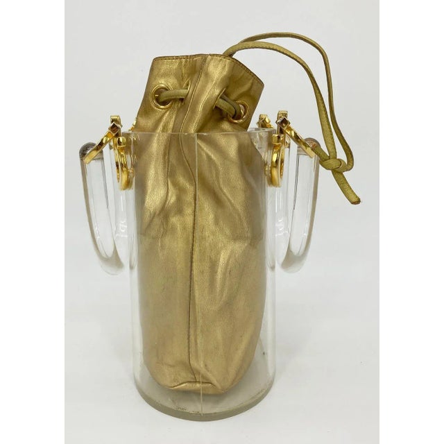 Vintage Salvatore Ferragamo Clear Bucket Bag with Gold Pouch in fair condition. Clear acrylic curved hardshell bucket with...