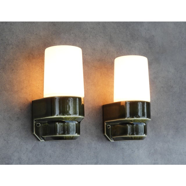 A rare pair of swedish mid-century ifö 6081 wall lights, dating from the 1970s. Sculptural glazed porcelain wall mounts in...