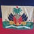 The Haiti Ensign flag is a horizontal bicolour of blue (top) and red (bottom) with a white square in the center bearing...